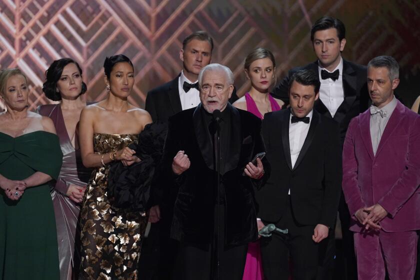 A group of actors accept an award onstage