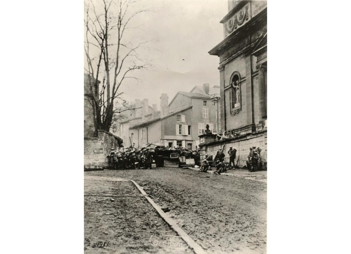 Nov. 11, 1918: Members of the 89th Infantry Division's 353rd Regiment, Company A, approach a church in Stenay, France, at 10:58 a.m., just two minutes before the end of World War I.