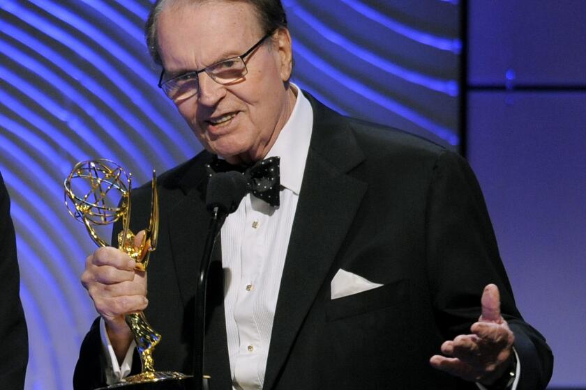 FILE - Charles Osgood accepts the award for outstanding morning program for "CBS Sunday Morning" at the 40th Annual Daytime Emmy Awards on June 16, 2013, in Beverly Hills, Calif. Osgood, who anchored the popular news magazine's for more than two decades, was host of the long-running radio program “The Osgood File” and was referred to as CBS News’ poet-in-residence, has died. He was 91. (Photo by Chris Pizzello/Invision/AP, File)