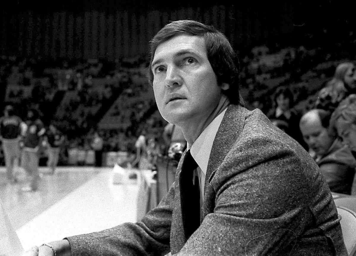 Jerry West, who was then the Lakers coach, sits on the sideline during a game in 1977. 