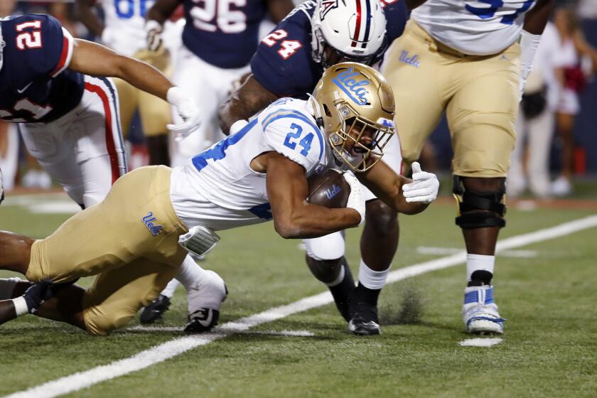 UCLA running back Zach Charbonnet (24) is brought down during the first half.