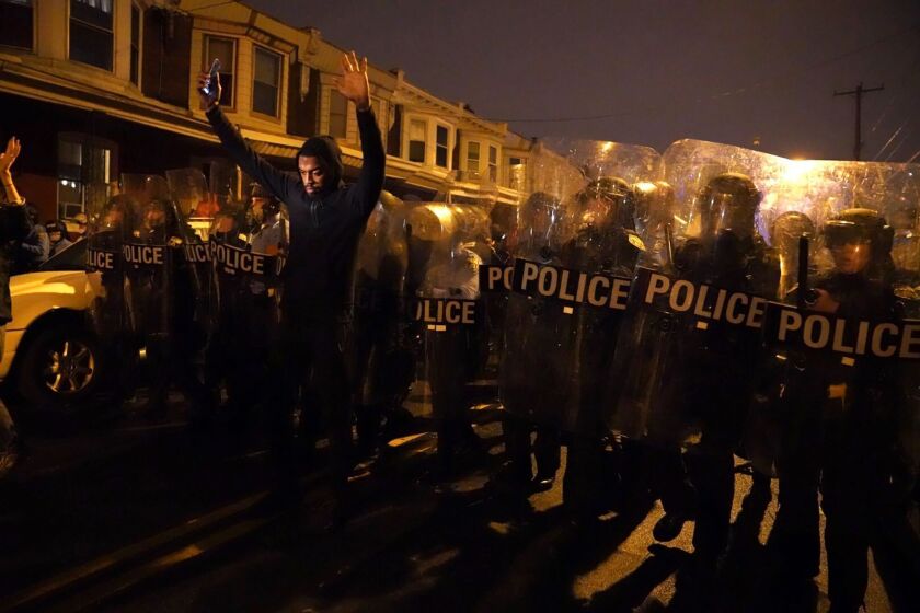 Sharif Proctor lifts his hands up in front of the police line during a protest in response to the police shooting of Walter Wallace Jr., Monday, Oct. 26, 2020, in Philadelphia. Police officers fatally shot the 27-year-old Black man during a confrontation Monday afternoon in West Philadelphia that quickly raised tensions in the neighborhood. (Jessica Griffin/The Philadelphia Inquirer via AP)
