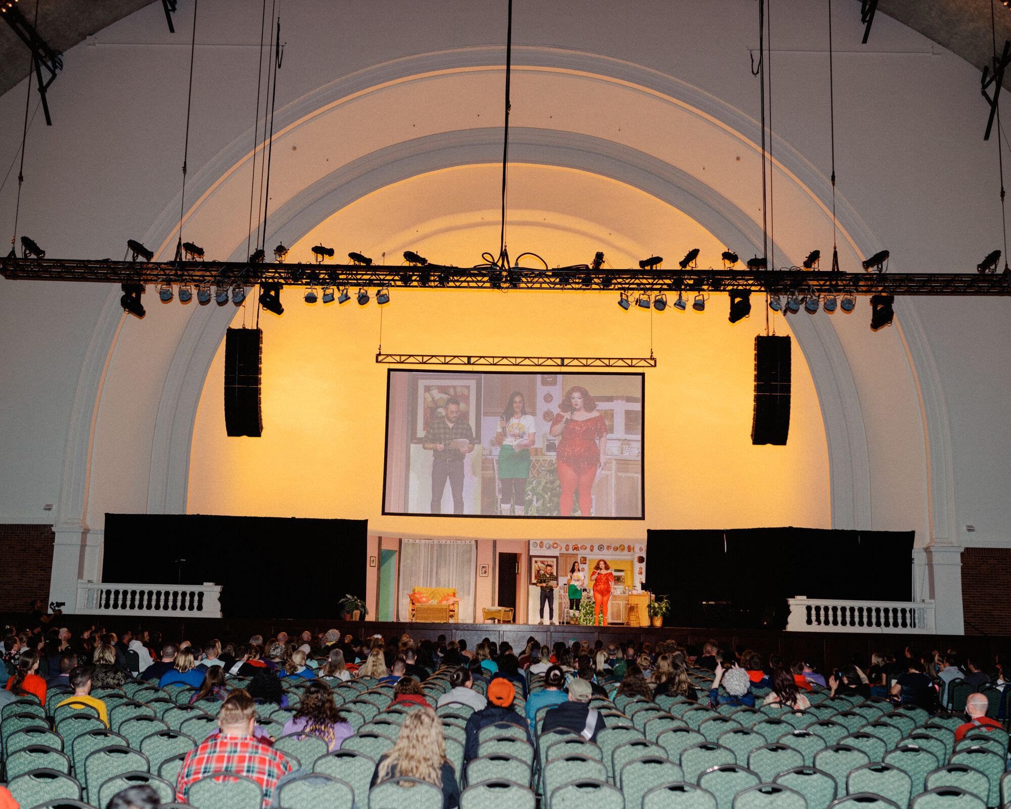 People seated in a convention hall.