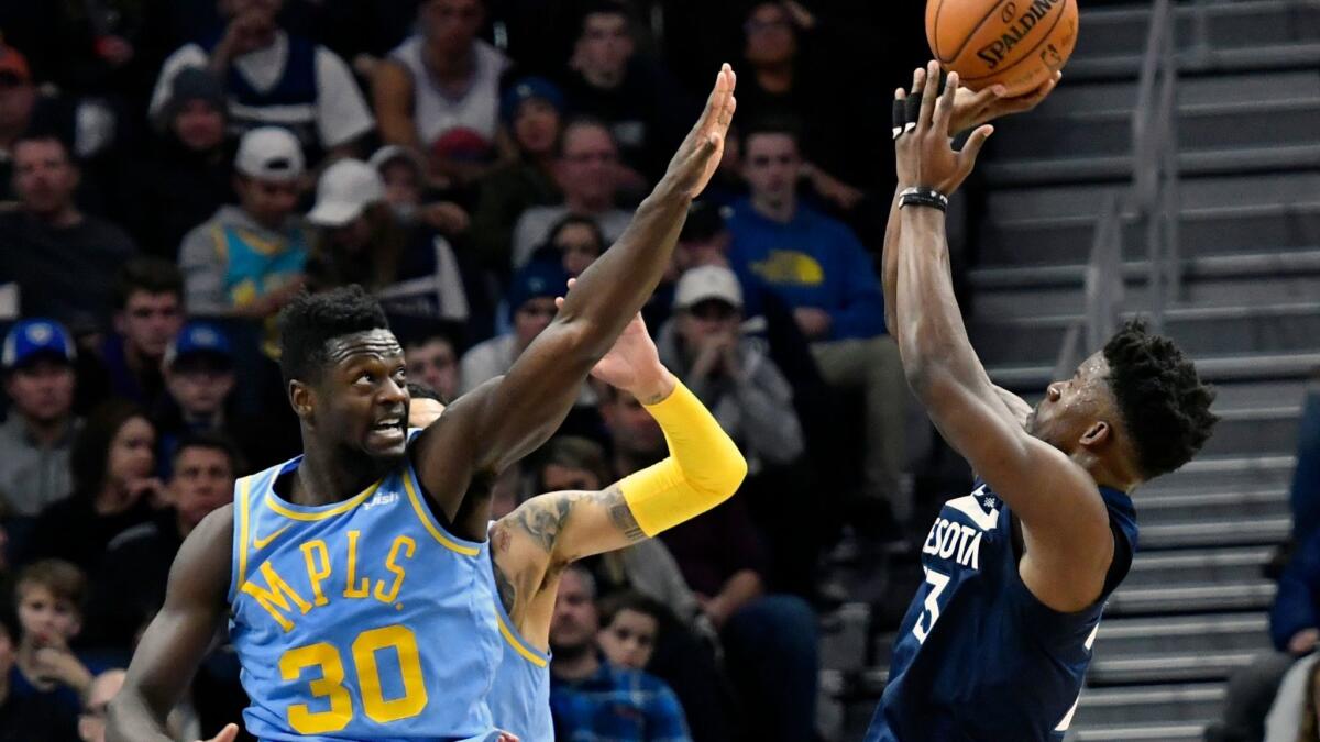 The Lakers' Julius Randle defends Minnesota's Jimmy Butler on Monday.