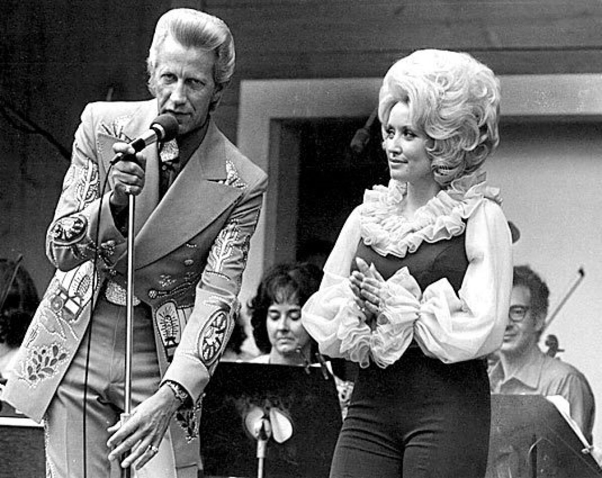 Country music stars Porter Wagoner and Dolly Parton perform at Opryland U.S.A. in 1975. Parton was on Blackwell's list four times between 1978 and 1981.