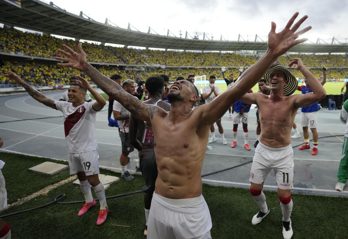 Peruvian players celebrate at the end of the game against Colombia  