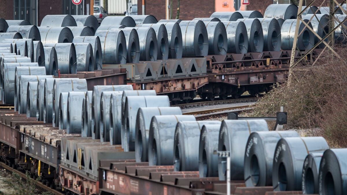 Coils of steel stand on trains in front of the ThyssenKrupp steel mill in March in Duisburg, Germany.