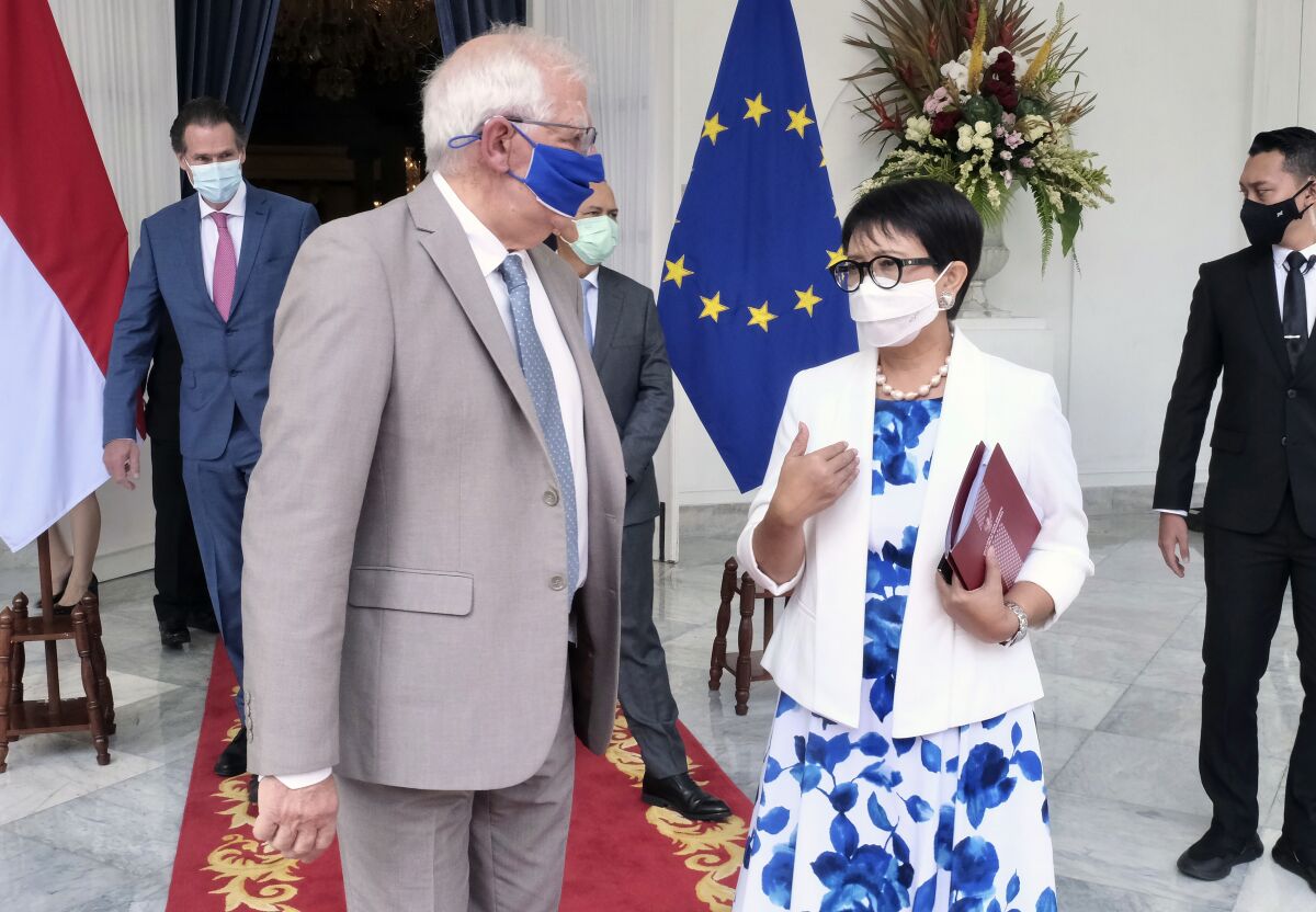 In this photo released by Indonesian Ministry of Foreign Affairs, Indonesian Foreign Minister Retno Marsudi, right, talks with European Union foreign affairs chief Josep Borrell during their meeting in Jakarta, Indonesia, Wednesday, June 2, 2021. Indonesia's foreign minister on Wednesday urged the Association of Southeast Asia Nations to immediately appoint a special envoy on Myanmar following a coup, and reiterated a call for the safety of civilians as the ruling junta cracks down on opposition. (Indonesian Ministry of Foreign Affairs via AP)