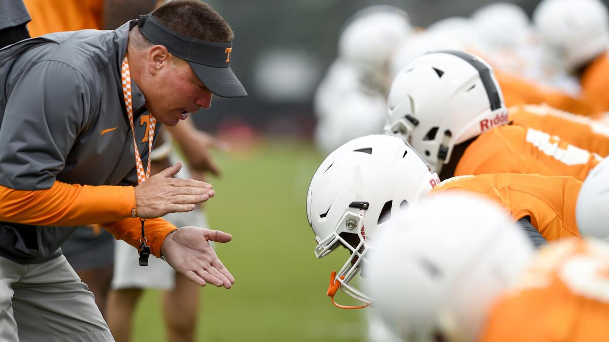 Volunteers Coach Butch Jones works with linemen during a practice on Tuesday in Knoxville, Tenn.