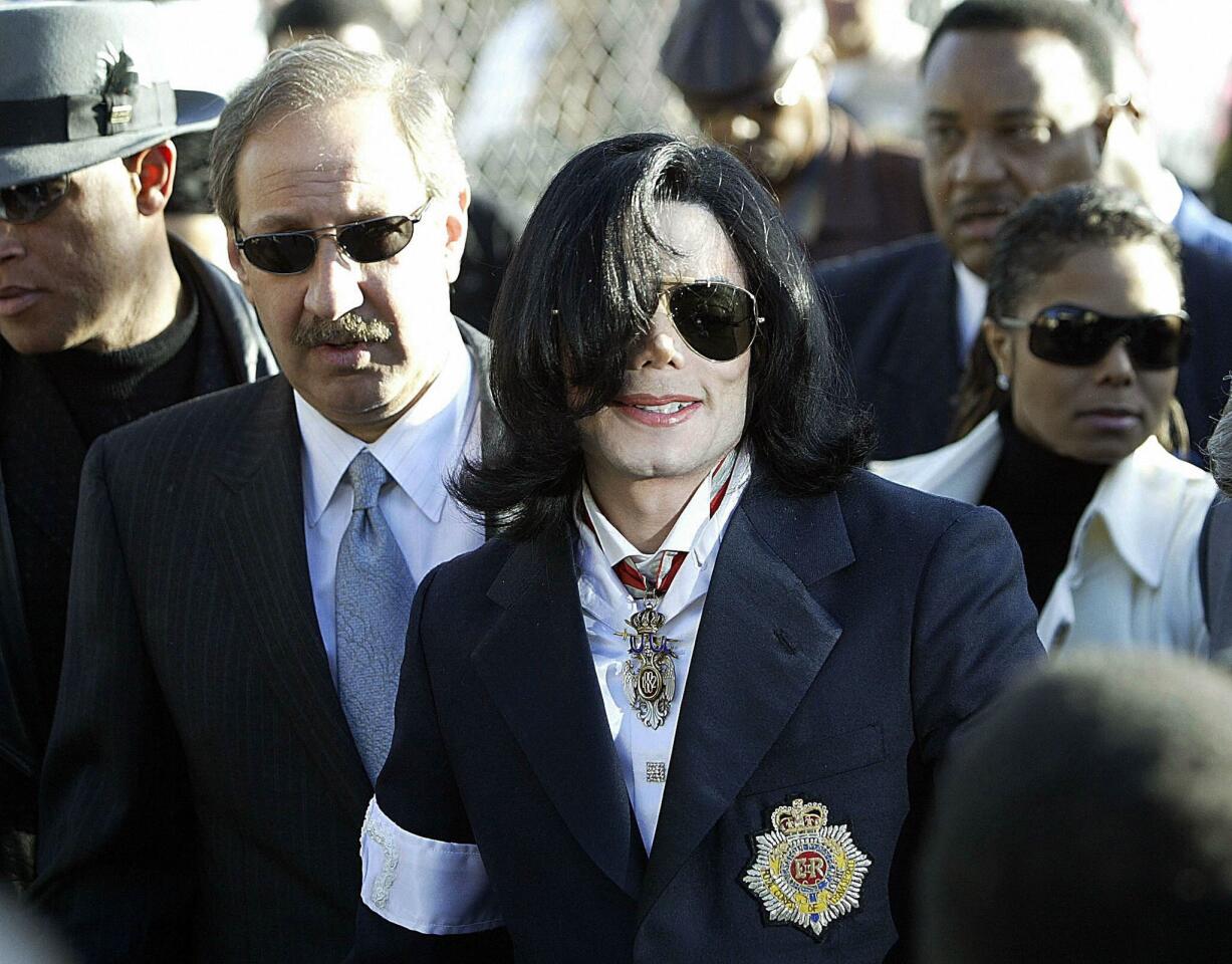 Mark Geragos, left, Michael Jackson and his sister Janet Jackson arrive for the King of Pop's arraignment on child molestation charges at the courthouse in Santa Maria, Calif., in January 2004.