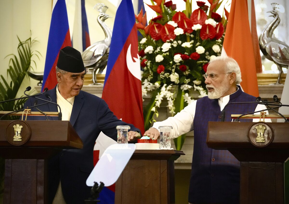 Indian Prime Minister Narendra Modi, right, and his Nepalese counterpart Sher Bahadur Deuba remotely inaugurate a railway line between Jaynagar in India to Kurthal in Nepal, in New Delhi, India, Saturday, April 2, 2022. Deuba is on a three-day official visit to India. (AP Photo/Manish Swarup)