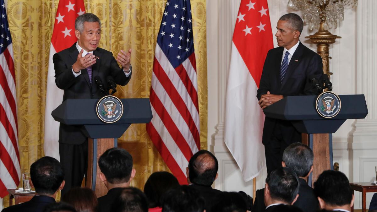 President Barack Obama listens as Singapore's Prime Minister Lee Hsien Loong speaks during their joint news conference at the White House on Aug. 2. The Trans-Pacific Partnership was high on the agenda during the Prime Minister's visit to Washington.