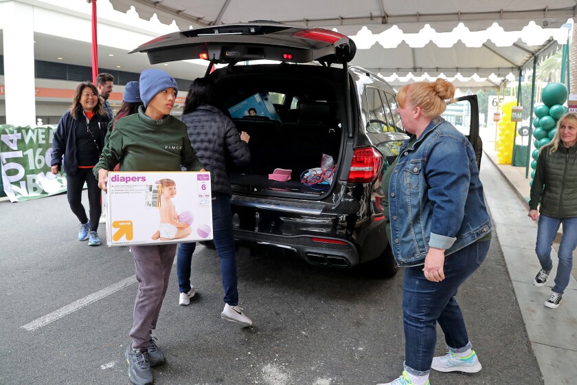 Volunteers unload donations during the 14th annual 'Share the Harvest' drive-thru donation event.