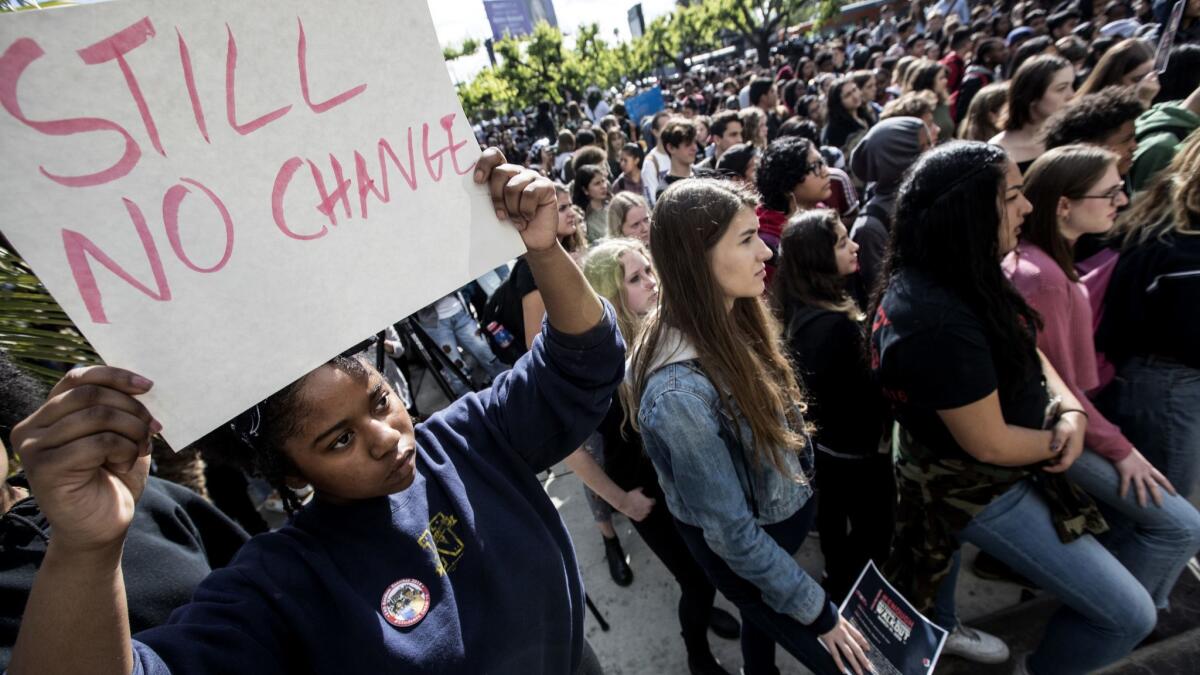Hamilton High School student Aiyana Dab'riel holds a sign during a March 14 walkout in support of the shooting victims in Parkland, Fla. Students nationwide will rally again on Saturday.