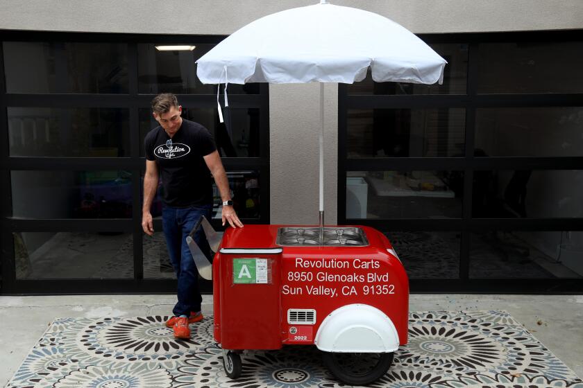 CULVER CITY, CA - MAY 28, 2024 - Matt Geller, a co-founder of Revolution Carts, stands next to the first permitted Tamalero food cart the company made. Geller was photographed at his home in Culver City on May 28, 2024. The company has made 87 Tamalero food carts to date. A $6 million LA County effort to build and distribute 200 food carts to local vendors for free is lagging - and vendors are suffering, according to Geller. While the county has been working with a nonprofit called Inclusive Action (since 2022) to build and distribute the 200 carts, Revolution has released a code-complaint cart of its own: the Tamalero, which can be used for tamales, breakfast burritos, hot dogs and more. Geller says the County's lack of expertise on the matter is delaying the project. But county officials contend that their program, which is funded by federal COVID-19 stimulus money, is doing far more than just building carts. They say that the educational components of their program are key to its success - and must come before any carts are distributed. (Genaro Molina/Los Angeles Times)