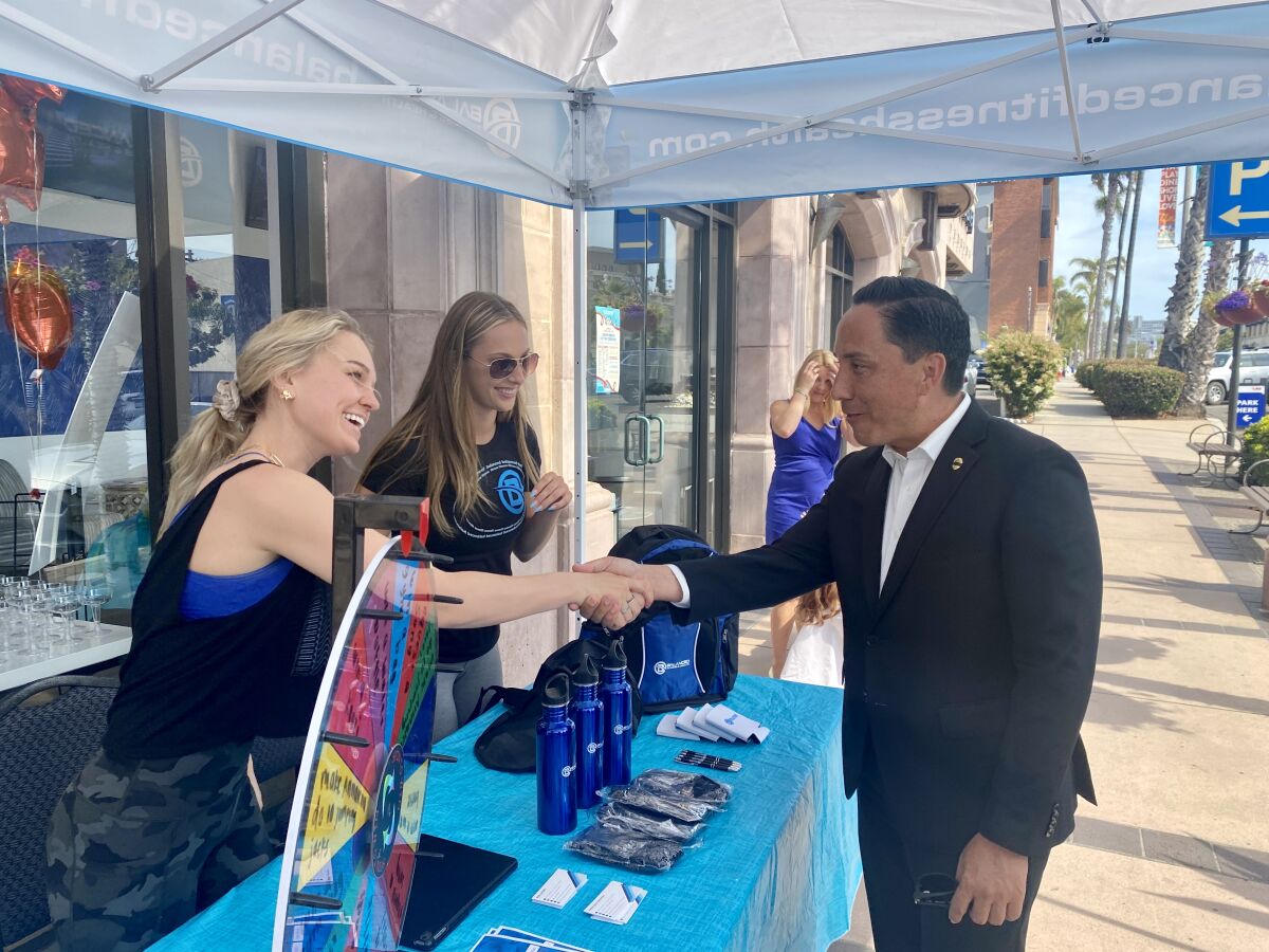 Mayor Todd Gloria chats with Annalena Dickman (left) and Casey Charland of Balanced Fitness & Health on Girard Avenue.