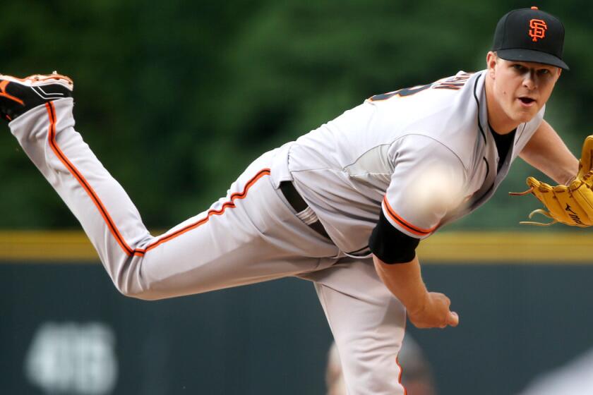 Giants starting pitcher Matt Cain works against the Colorado Rockies in the first inning of a game on Wednesday in Denver.