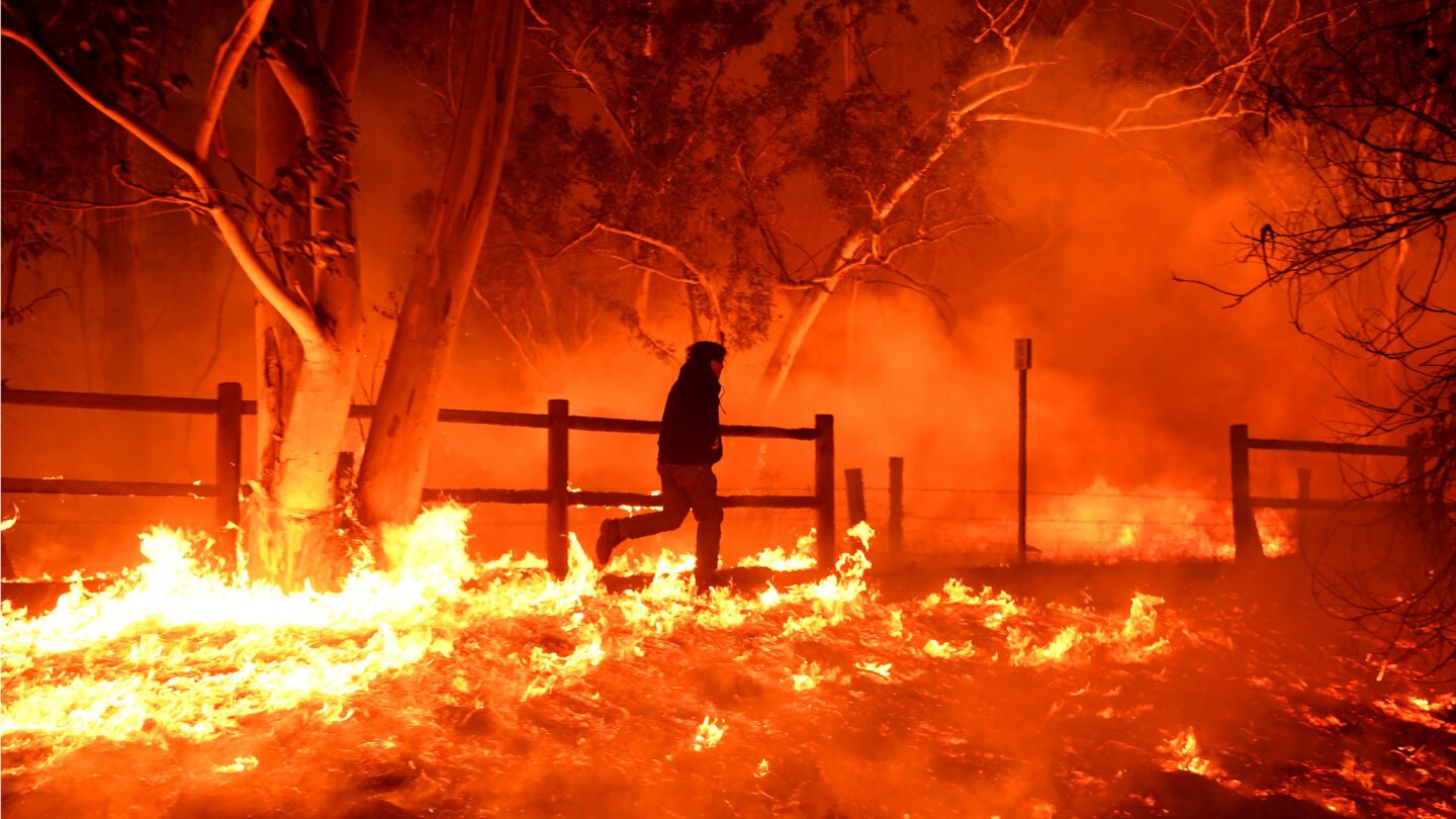 Edward Aguilar runs through the flames of the Thomas Fire to save his cats at his mobile home along Highway 33 in Casitas Springs in Ventura County.