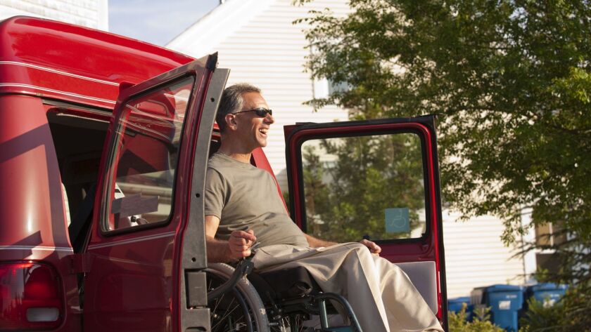 Wheelchair Accessible Camper Vans For Sale, Man In Wheelchair Being Lowered From Accessible Van, Wheelchair Accessible Camper Vans For Sale