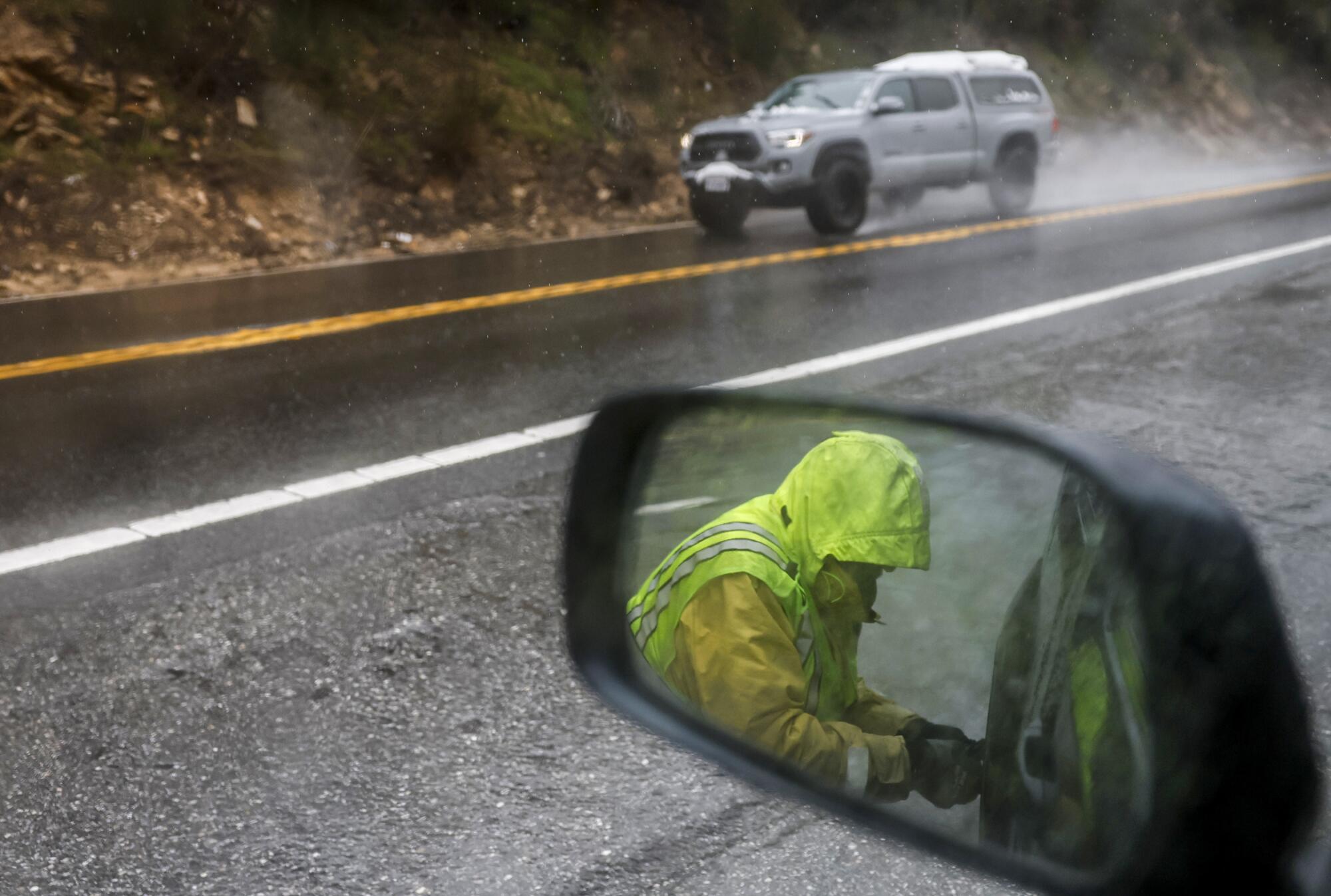 Chain installer Bill Siples at work along State Highway 330 on the way to Big Bear