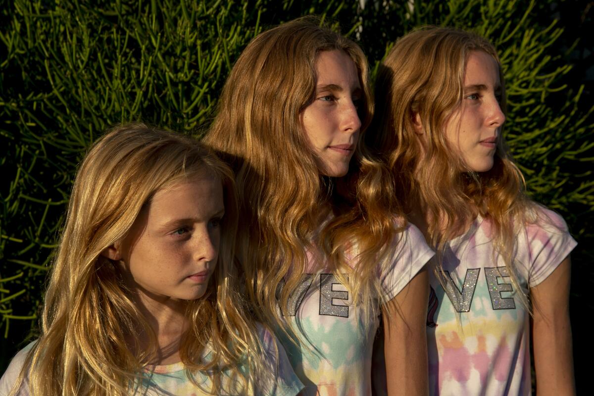 Bixby, 11, Brinkley, 15, and Brooklyn Baker, 15, pose together along Abbott Kinney in Venice on Friday, Sept. 25, 2020.