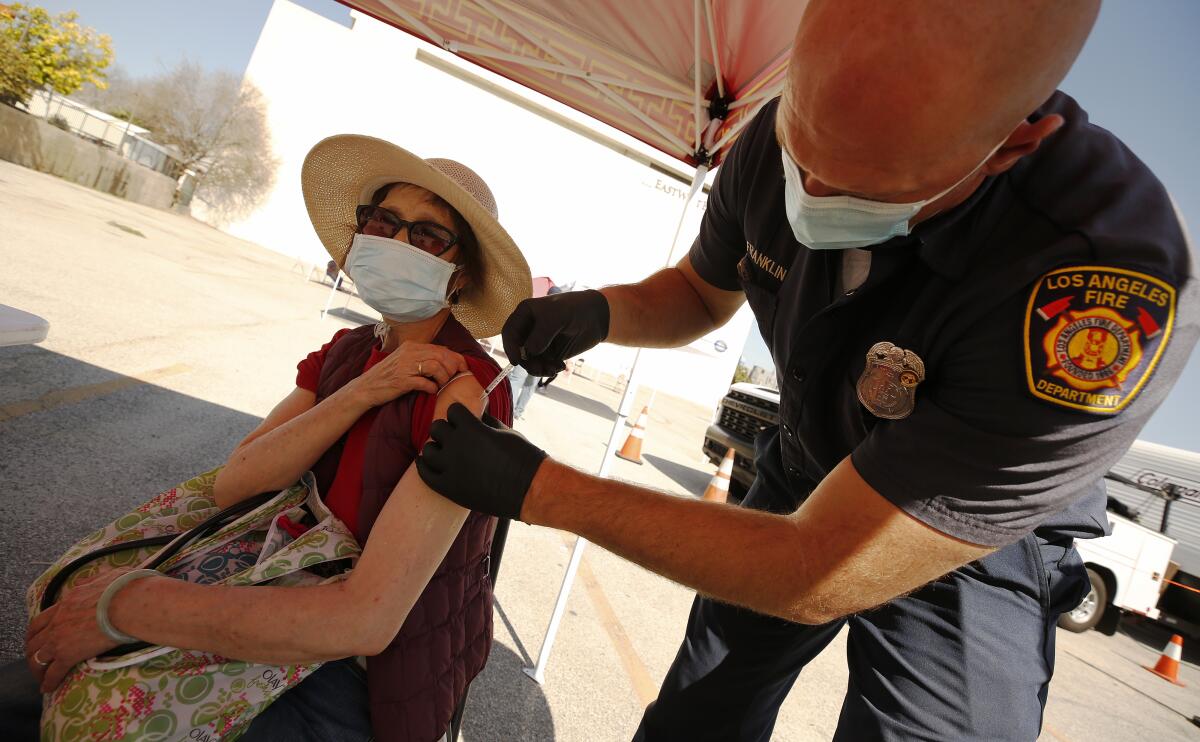 Yuyao Lui, 76, receives a COVID-19 vaccine shot.