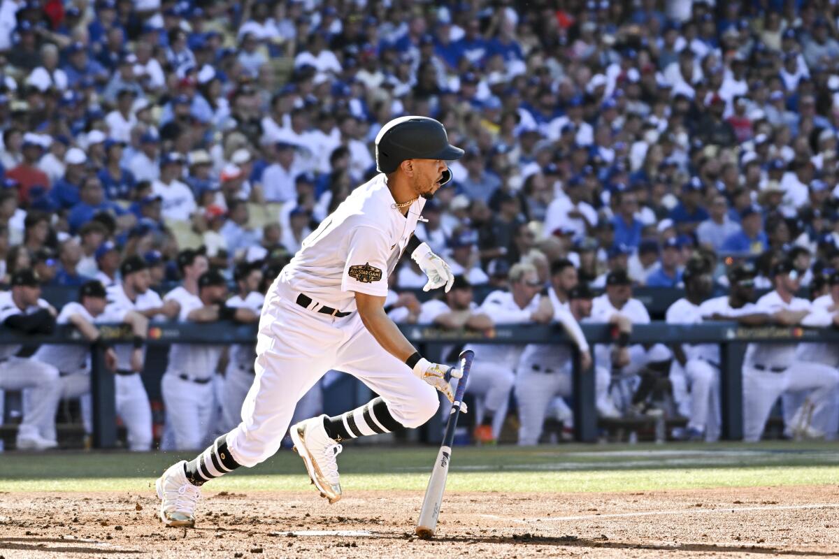 National League outfielder Mookie Betts, of the Dodgers, looks up after hitting a single.
