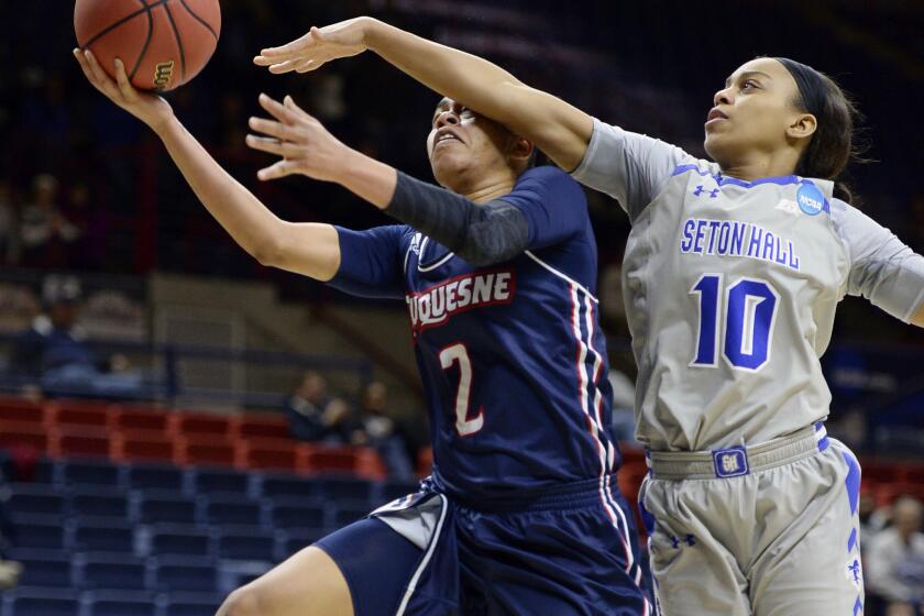 Duquesne’s Deva'Nyar Workman is fouled by Seton Hall’s Jordan Mosley during the second half of a game on March 19.