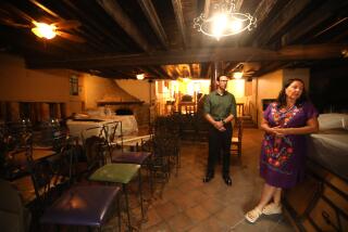 LOS ANGELES, CA - SEPTEMBER 28, 2023 - Bertha Gomez, right, and her son David Gomez, the new owners of La Golondrina Cafe, stand inside the famed restaurant that remains closed on Olvera Street in El Pueblo de Los Angeles on September 28, 2023. The Gomez' have not been able to open the business because of a damaged sewer line into the building. La Golondrina Cafe]has been closed since March 2020. They are locked in a lawsuit with the city, because they claim that the city is responsible for the repairs, while the city argues otherwise. The Board of El Pueblo de Los Angeles Historical Monument Authority Commission on Thursday oversaw a hearing and decided that the Gomez' should be evicted from the location, nearly 95 years after the business first opened. The previous owners were the original family who started the business and it's considered one of the oldest Mexican restaurants in the city. (Genaro Molina / Los Angeles Times)