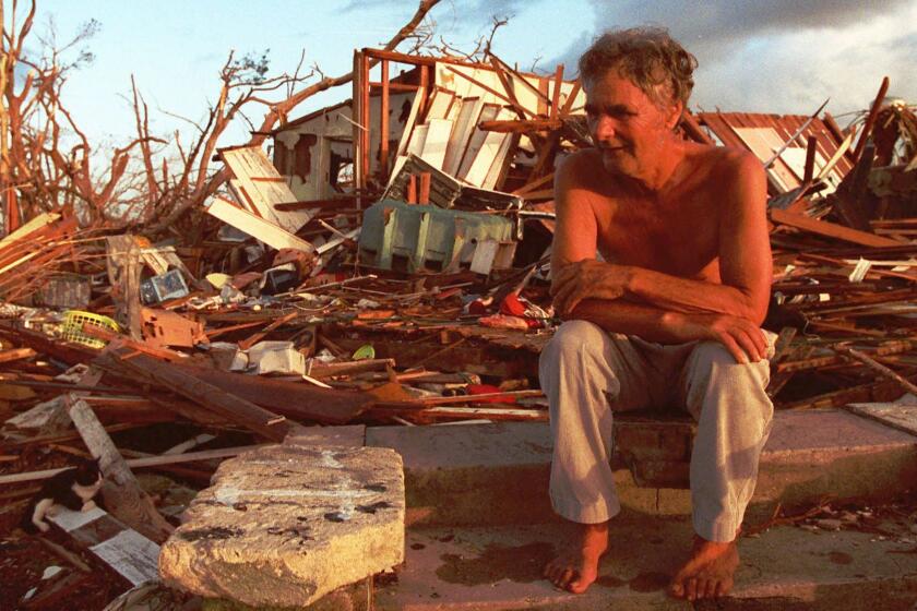 Janny Vancedarfield sits in front of the debris that was once his house September 1, 1992, in Florida City, Fla. Vancedarfield lived in this house with six other family members before it was destroyed by Hurricane Andrew in August 1992. This summer marks the five year anniversary of the hurricane. (AP Photo/Lynn Sladky)