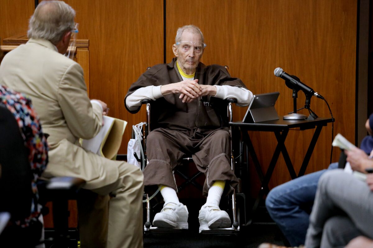 Robert Durst, 78, testifies in his murder trial answering questions from defense attorney Dick DeGuerin, left.