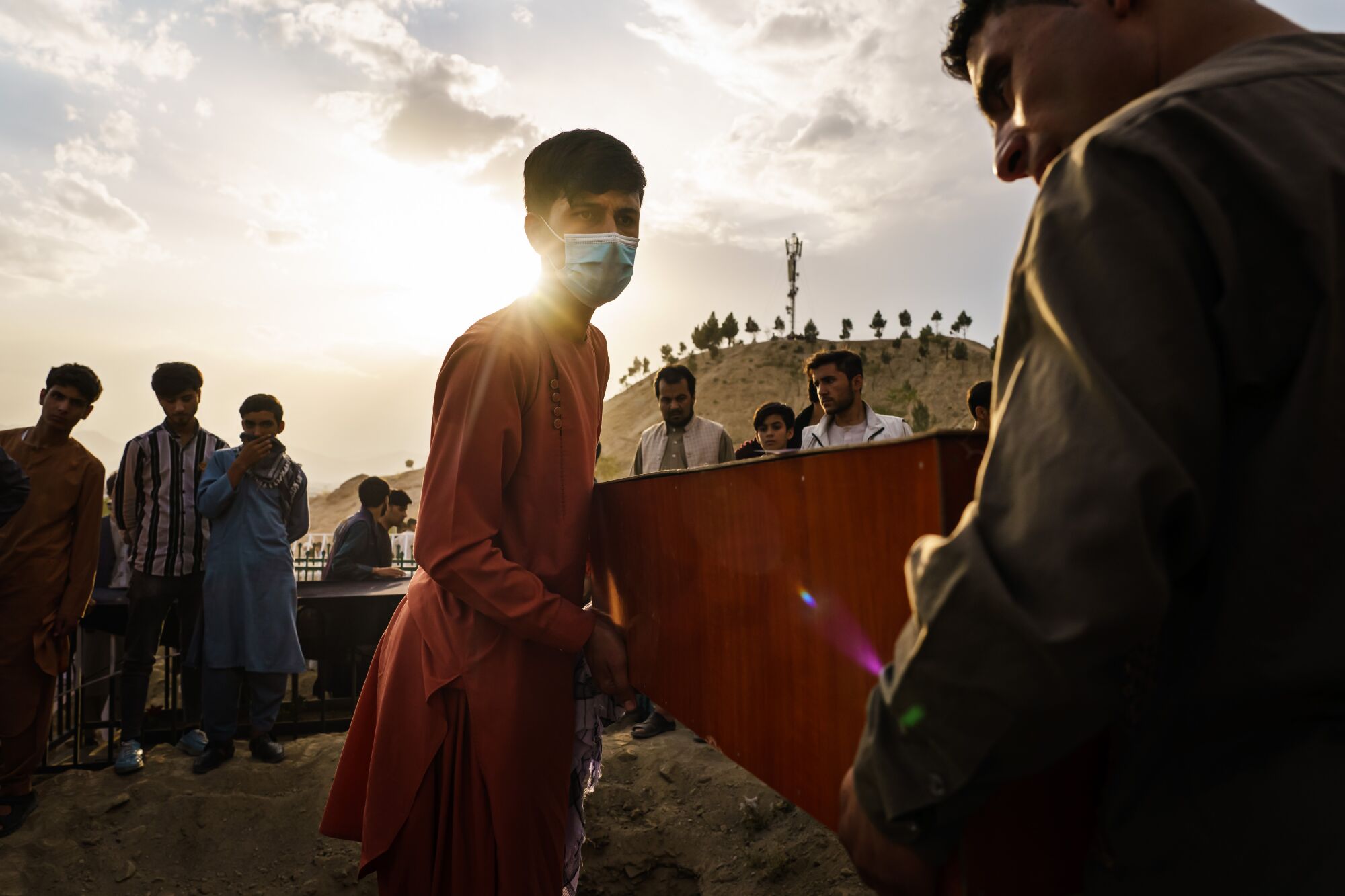 Relatives carry the caskets of the victims of Sunday's blast toward the gravesite.
