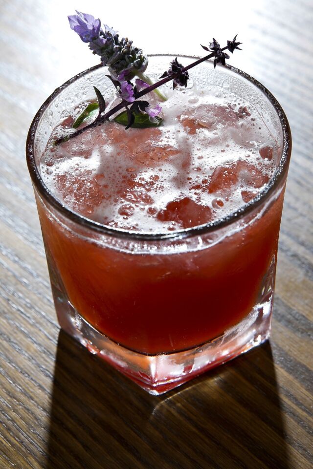The Scarlet O'Hara has bourbon, pomegranate, Peychaud's bitters, watermelon basil shrub, with a piece of purple Thai basil and lavender leaf from the Chef's Garden next door, for $12.