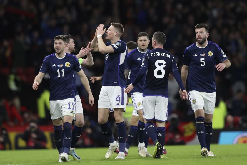 Scotland's Scott McTominay, third from left, celebrates with his teammates after scoring his side's second goal during the Euro 2024 group A qualifying soccer match between Scotland and Spain at the Hampden Park stadium in Glasgow, Scotland, Tuesday, March 28, 2023. (AP Photo/Scott Heppell)