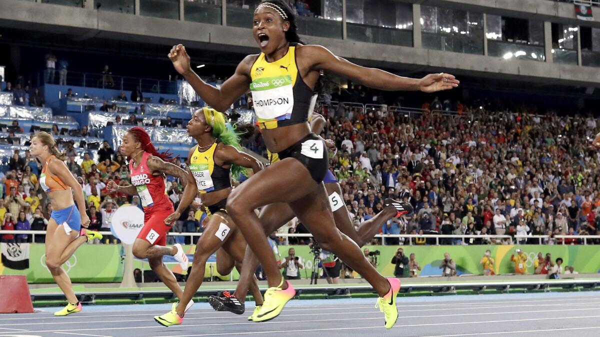 Jamaica's Elaine Thompson reacats after crossing the finish line first in the women's 100-meter dash on Saturday.
