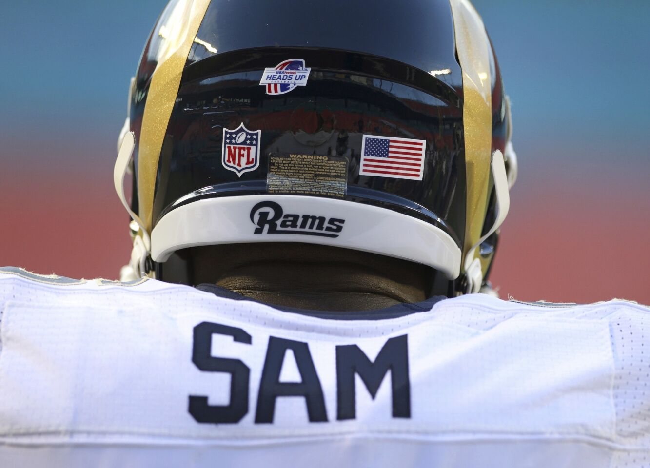 Rams defensive end Michael Sam takes is the first openly gay player drafted by an NFL team.