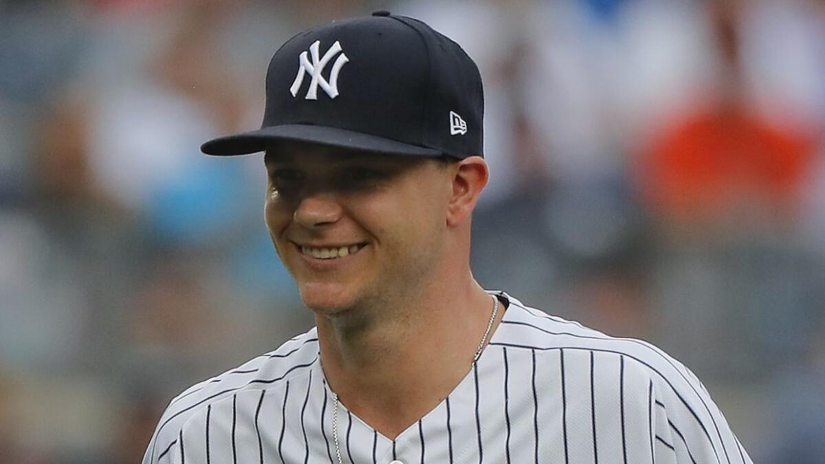 New York Yankees starting pitcher Sonny Gray, left, reacts as he leaves the game during the third inning of a baseball game against the Baltimore Orioles on Aug. 1 in New York. The Orioles won 7-5.
