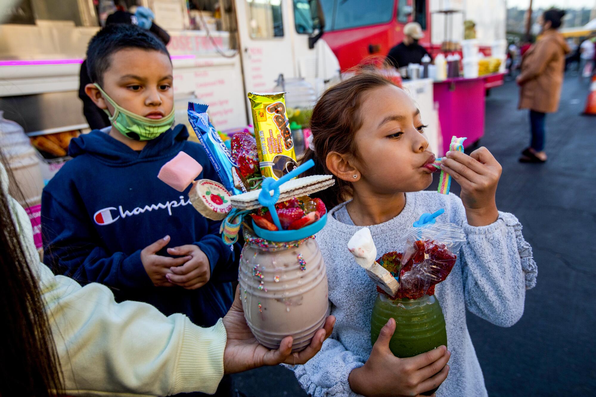 Kids enjoy treats from the Sugar Box L.A. food truck at the Avenue 26 night market in Lincoln Heights.