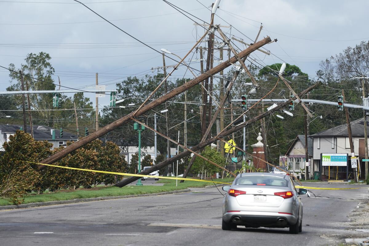 Traffic diverts around downed power lines and sideways power poles