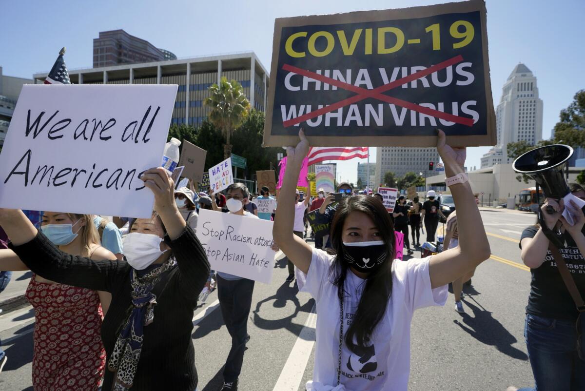Protestors march at a rally against Asian hate crimes past the Los Angeles Federal Building in downtown Los Angeles.