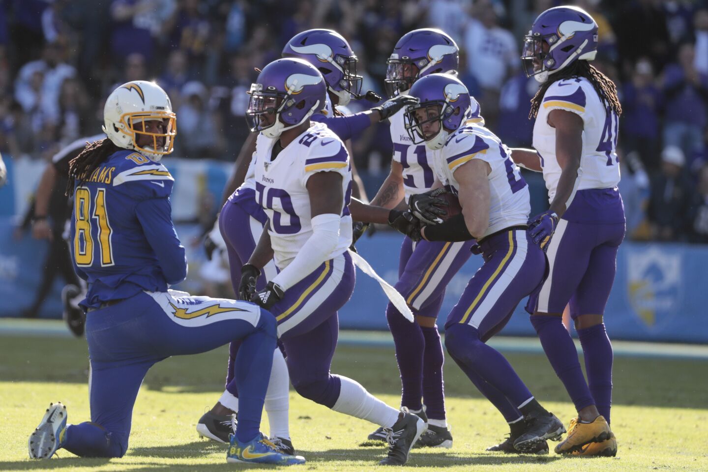 Chargers wide receiver Mike Williams looks on as Minnesota Vikings cornerback Mike Hughes celebrates with teammates after intercepting a pass by Chargers quarterback Philip Rivers.
