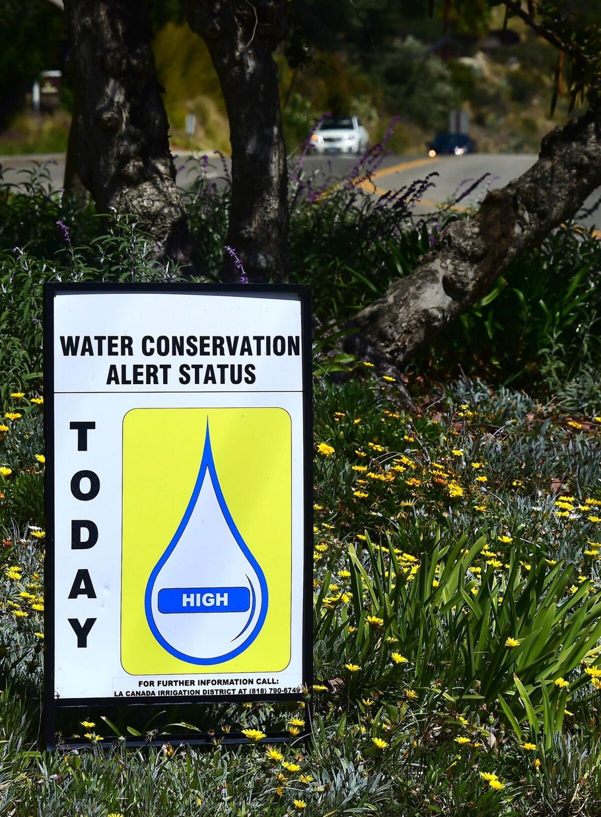 A sign posted roadside warns passing motorists of the Water Conservation Alert Status on April 8, 2015 in La Cañada Flintridge, Calif.