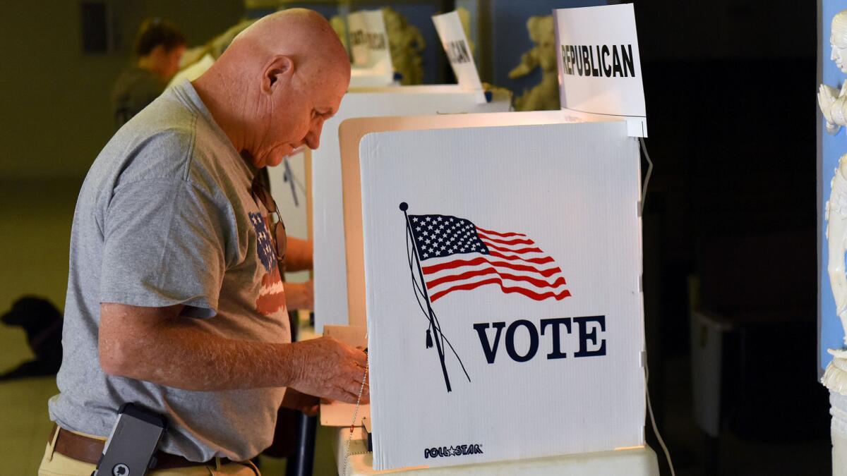 A voter casts his ballot in 2016, before California's new early voting protocols were instituted.