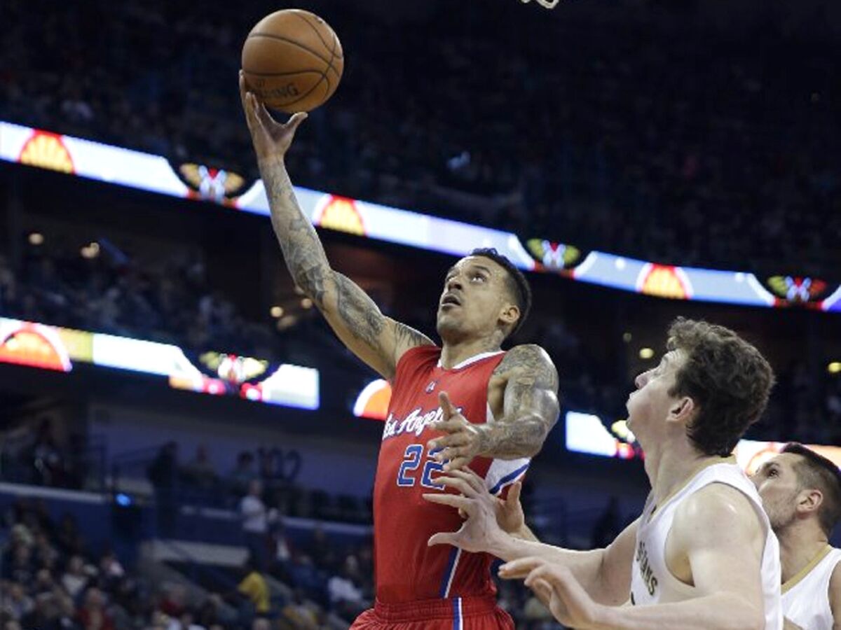 Clippers forward Matt Barnes shoots a layup in front of Pelicans center Omer Asik in the first half.