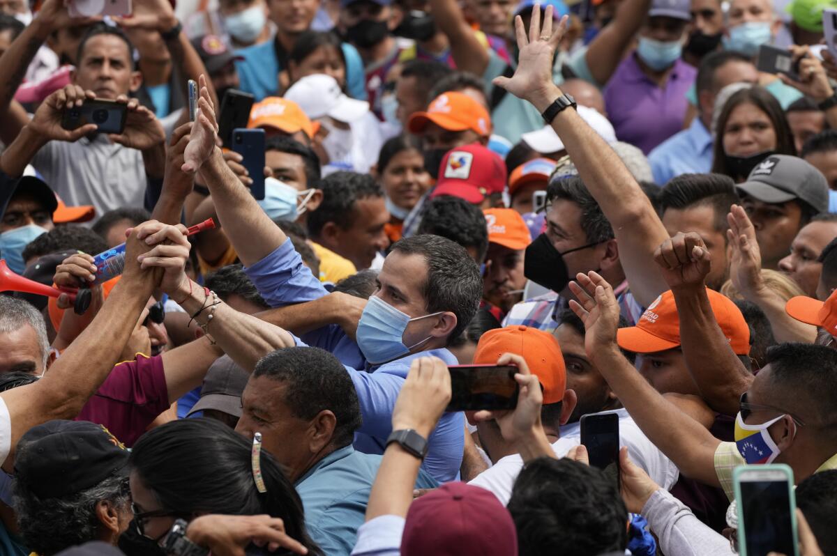 Opposition leaders Juan Guaido and Freddy Superlano in a crowd of supporters 