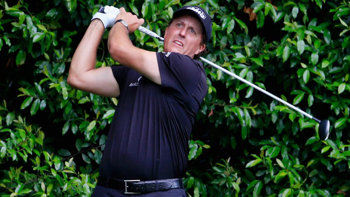 Phil Mickelson watches his tee shot on the fifth hole during the final round of the Masters at Augusta National Golf Club on April 12.