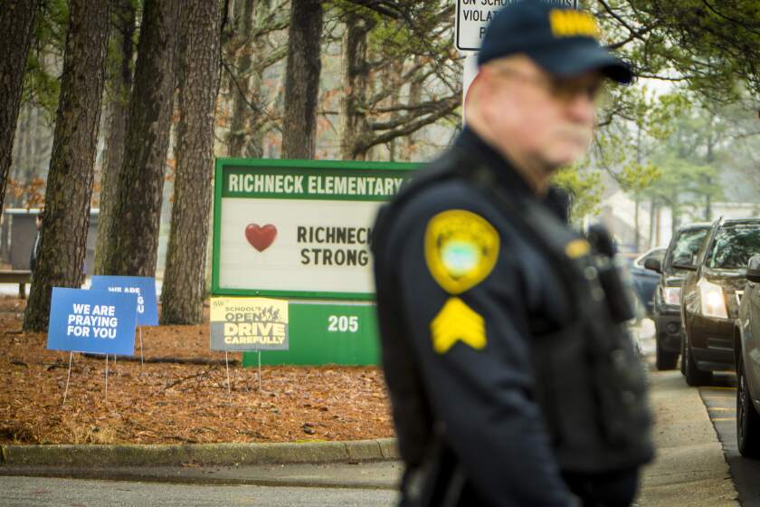 A Newport News police officer directs traffic at Richneck Elementary School in Newport News, Va., on Monday Jan. 30, 2023. The Virginia elementary school where a 6-year-old boy shot his teacher has reopened with stepped-up security and a new administrator. (AP Photo/John C. Clark)
