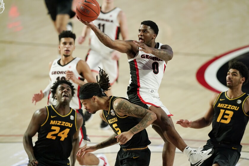 Georgia guard K.D. Johnson (0) is fouled by Missouri forward Mitchell Smith (5) during the second half of an NCAA college basketball game Tuesday, Feb. 16, 2021, in Athens, Ga. (AP Photo/Brynn Anderson)