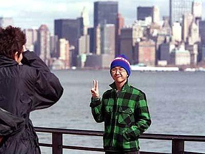 Tourists photograph the skyline without the towers