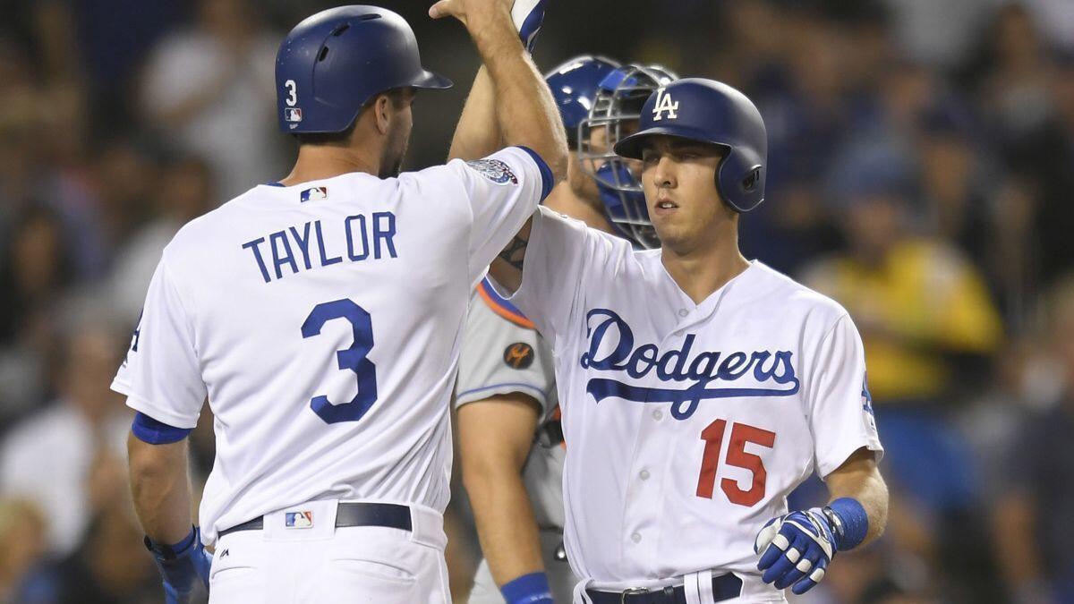 Dodgers' Chris Taylor congratulates Austin Barnes on his two-run home run against the New York Mets during the fourth inning on Tuesday.